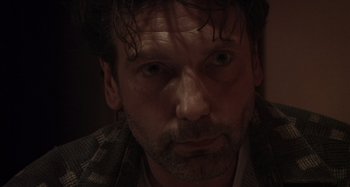 Movie still from “Inland Empire” (2006), directed by David Lynch – A person with a beard; Close Up shot, Over the shoulder angle