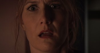 Movie still from “Inland Empire” (2006), directed by David Lynch – A woman's face in the dark; Close Up shot, Over the shoulder angle