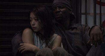 Movie still from “Inland Empire” (2006), directed by David Lynch – A man and a woman sitting next to each other; Close Up shot, Low angle