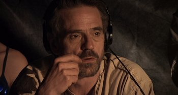 Movie still from “Inland Empire” (2006), directed by David Lynch – A person wearing headphones; Close Up shot, High angle