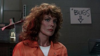 Movie still from “Innerspace” (1987), directed by Joe Dante – A person wearing an orange jacket; Close Up shot, Over the shoulder angle