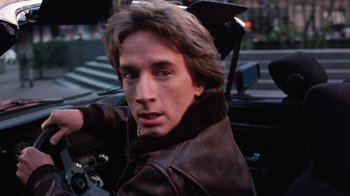 Movie still from “Innerspace” (1987), directed by Joe Dante – A person riding a motorcycle on a city street; Close Up shot, Low angle
