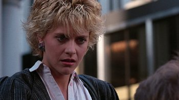 Movie still from “Innerspace” (1987), directed by Joe Dante – A person wearing a suit and tie; Close Up shot, Over the shoulder angle