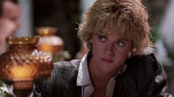 Movie still from “Innerspace” (1987), directed by Joe Dante – A person wearing a suit and tie; Close Up shot, Over the shoulder angle