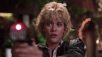 Movie still from “Innerspace” (1987), directed by Joe Dante – A person holding a cell phone; Close Up shot, Low angle