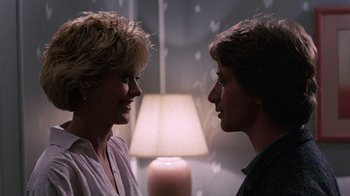 Movie still from “Innerspace” (1987), directed by Joe Dante – A man and a woman talking to each other; Close Up shot, Over the shoulder angle