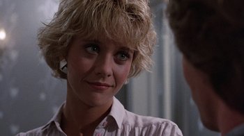Movie still from “Innerspace” (1987), directed by Joe Dante – A person wearing a button up shirt; Close Up shot, Over the shoulder angle