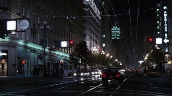 Movie still from “Innerspace” (1987), directed by Joe Dante – A city street at night lit up by streetlights; Extreme Wide shot, High angle