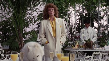 Movie still from “Innerspace” (1987), directed by Joe Dante – A woman standing in front of a table filled with drinks; Medium shot, Low angle