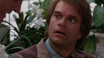 Movie still from “Innerspace” (1987), directed by Joe Dante – A person with long brown hair; Close Up shot, Over the shoulder angle