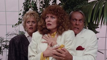 Movie still from “Innerspace” (1987), directed by Joe Dante – A group of people standing next to each other; Medium shot, Low angle