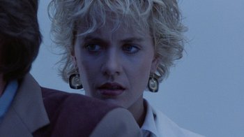 Movie still from “Innerspace” (1987), directed by Joe Dante – A person with short blonde hair; Close Up shot, Over the shoulder angle