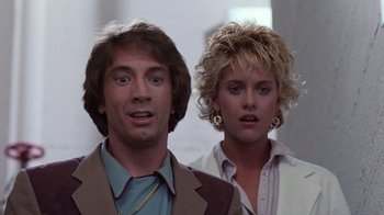 Movie still from “Innerspace” (1987), directed by Joe Dante – A man and a woman standing next to each other; Close Up shot, Low angle