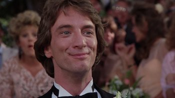 Movie still from “Innerspace” (1987), directed by Joe Dante – A person wearing a suit and bow tie; Close Up shot, Low angle