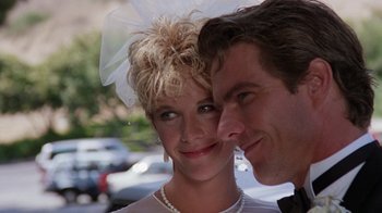 Movie still from “Innerspace” (1987), directed by Joe Dante – A man and a woman smiling for the camera; Close Up shot, Low angle