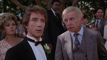 Movie still from “Innerspace” (1987), directed by Joe Dante – Two men in tuxedos standing next to each other; Close Up shot, Over the shoulder angle