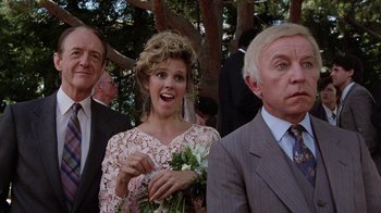 Movie still from “Innerspace” (1987), directed by Joe Dante – A woman in a wedding dress holding a bouquet of flowers; Medium shot, Over the shoulder angle