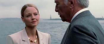 Movie still from “Inside Man” (2006), directed by Spike Lee – A woman standing next to an older man near a body of water; Close Up shot, Over the shoulder angle