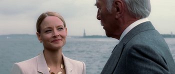 Movie still from “Inside Man” (2006), directed by Spike Lee – A woman standing next to an older man near a body of water; Close Up shot, Over the shoulder angle