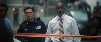 Movie still from “Inside Man” (2006), directed by Spike Lee – Two police officers standing in front of a barricade; Medium shot, Low angle
