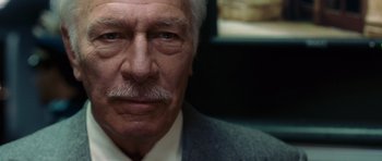 Movie still from “Inside Man” (2006), directed by Spike Lee – An older man wearing a white shirt and a gray suit; Close Up shot, Low angle