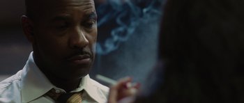 Movie still from “Inside Man” (2006), directed by Spike Lee – A person smoking a cigarette; Close Up shot, Over the shoulder angle