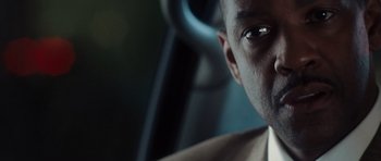 Movie still from “Inside Man” (2006), directed by Spike Lee – A man's face in a car; Close Up shot, Over the shoulder angle