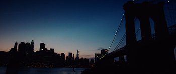 Movie still from “Inside Man” (2006), directed by Spike Lee – A view of a city skyline at night with a bridge; Extreme Wide shot, Low angle