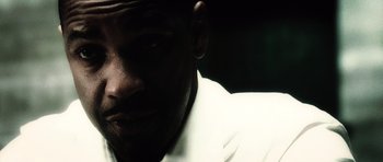Movie still from “Inside Man” (2006), directed by Spike Lee – A man in a white shirt; Extreme Close Up shot, Low angle