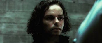 Movie still from “Inside Man” (2006), directed by Spike Lee – A person with long dark hair; Close Up shot, Low angle