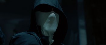 Movie still from “Inside Man” (2006), directed by Spike Lee – A person wearing a mask and a black jacket; Close Up shot, Low angle