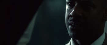 Movie still from “Inside Man” (2006), directed by Spike Lee – A man's face in the dark; Extreme Close Up shot, Over the shoulder angle