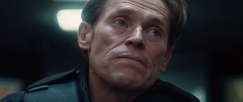 Movie still from “Inside Man” (2006), directed by Spike Lee – A person wearing a black jacket; Close Up shot, Low angle