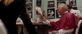 Movie still from “Inside Man” (2006), directed by Spike Lee – An older woman holding a book in her hand; Medium shot, Over the shoulder angle