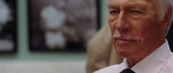 Movie still from “Inside Man” (2006), directed by Spike Lee – An older man with a mustache and a beard; Close Up shot, Low angle