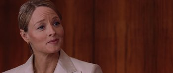 Movie still from “Inside Man” (2006), directed by Spike Lee – A person wearing a suit; Close Up shot, Over the shoulder angle