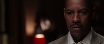 Movie still from “Inside Man” (2006), directed by Spike Lee – A person wearing a shirt and tie; Close Up shot, Over the shoulder angle