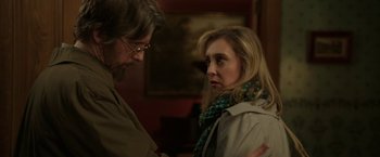 Movie still from “Insidious: Chapter 2” (2013), directed by James Wan – A man and a woman standing next to each other in a room; Close Up shot, Over the shoulder angle