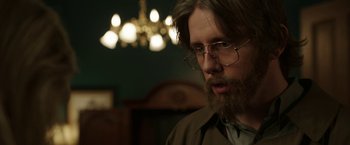 Movie still from “Insidious: Chapter 2” (2013), directed by James Wan – A man with long hair and glasses is looking to his left; Close Up shot, Over the shoulder angle