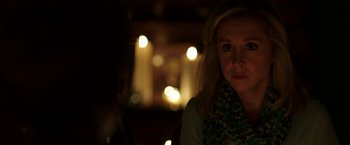 Movie still from “Insidious: Chapter 2” (2013), directed by James Wan – A woman is sitting in front of some lights; Close Up shot, Over the shoulder angle