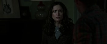 Movie still from “Insidious: Chapter 2” (2013), directed by James Wan – A woman in a dark room looking sad with her eyes wide open; Close Up shot, Over the shoulder angle