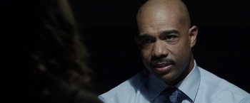 Movie still from “Insidious: Chapter 2” (2013), directed by James Wan – A man with a bald head wearing a tie; Close Up shot, Over the shoulder angle