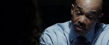 Movie still from “Insidious: Chapter 2” (2013), directed by James Wan – A person wearing a shirt and tie; Close Up shot, Over the shoulder angle