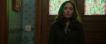 Movie still from “Insidious: Chapter 2” (2013), directed by James Wan – A woman standing in front of a stained glass window; Close Up shot, Over the shoulder angle