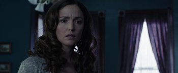 Movie still from “Insidious: Chapter 2” (2013), directed by James Wan – A person with long curly hair; Close Up shot, Over the shoulder angle