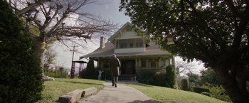 Movie still from “Insidious: Chapter 2” (2013), directed by James Wan – An older man walking down a sidewalk in front of a house; Extreme Wide shot, Low angle