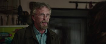 Movie still from “Insidious: Chapter 2” (2013), directed by James Wan – An older man wearing glasses and a jacket; Close Up shot, Over the shoulder angle