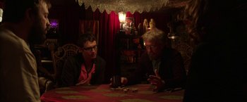 Movie still from “Insidious: Chapter 2” (2013), directed by James Wan – Two men sitting at a table playing a board game; Medium shot, Over the shoulder angle