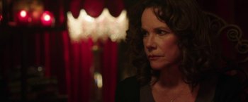 Movie still from “Insidious: Chapter 2” (2013), directed by James Wan – A person with curly brown hair; Close Up shot, Over the shoulder angle