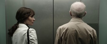 Movie still from “Insidious: Chapter 2” (2013), directed by James Wan – A woman and an older man in an elevator; Close Up shot, Over the shoulder angle